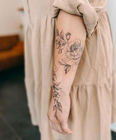 a woman with a flower tattoo on her arm