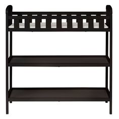 a black shelf with candles on it and two shelves below the shelf are white candles