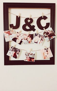 a photo frame with clothes pins hanging from it's sides and the word j & g spelled in black