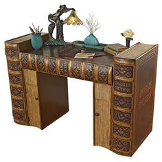 an antique desk with books and vases on it