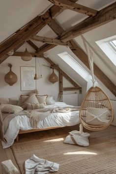 an attic bedroom with white linens and natural wood accents, including a hanging hammock