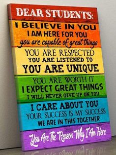 a wooden sign with the words dear students on it, and an image of a rainbow colored