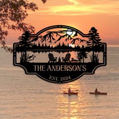 a couple of canoes floating on top of a body of water under a sunset