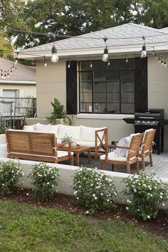 an outdoor living area with patio furniture and string lights