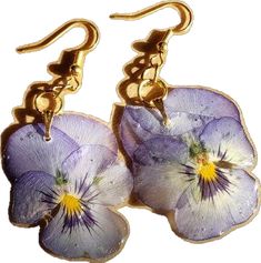 two purple pansies are hanging from gold earwires on a hook - back