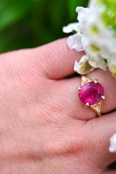 This exquisite Raspberry Rubellite Tourmaline and 14K Gold Ring boasts a captivating, natural pink and magenta gemstone at its center, adorned by eight VS G+ diamonds for extra radiance and placed on a resilient 14K yellow gold band. With its unparalleled durability, this ring is an excellent selection for an individualized and significant engagement ring. Ring and Gemstone Info: ♦️Metal: 14K Yellow Gold ♦️Size: 7 🔹Natural Rubellite Tourmaline: 3.74 cts (10.84 x 9.45mm) 🔸Natural Diamonds: (8 t Pink Diamond Gemstones With Accents, Elegant Pink Ruby Gemstones, Pink Oval Ruby Ring With Gemstone Accents, Pink Ruby Ring With Gemstone Accents, Pink Ruby Ring With Gemstone Accents For Anniversary, Rubellite Tourmaline, Solid Gold Ring, Solid Gold Rings, 14k Gold Ring