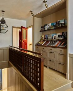 an entry way with bookshelves and wooden stairs