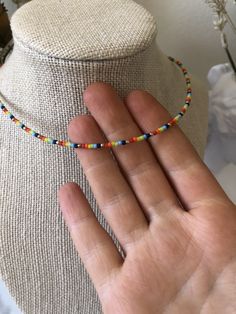 Handmade gold and rainbow bead necklace. Necklace is 15 inches + 2 inch extender. Perfect for layering with other ByRJJewelry! Care tips: - Avoid wearing your jewelry in water/while exercising to keep it looking beautiful for longer. - Removing jewelry before bed also helps to keep it looking its best. Adjustable Rainbow Choker Jewelry, Trendy Rainbow Jewelry With Tiny Beads, Adjustable Single Strand Rainbow Beads, Adjustable Rainbow Single Strand Beads, Adjustable Rainbow Choker With Round Beads, Rainbow Round Beads Adjustable Choker, Adjustable Rainbow Beaded Choker Necklaces, Rainbow Colorful Beads Choker, Adjustable Dainty Multicolor Choker