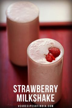 strawberry milkshake with whipped cream and fresh strawberries on the rim in two glasses