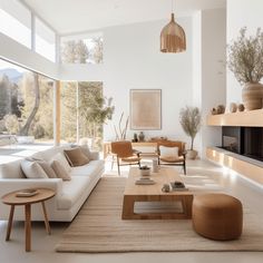 a living room filled with furniture and a fire place in front of a large window