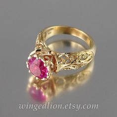 The ENCHANTED PRINCESS ring was designed by the artist and jewelry designer Sergey Zhiboedov. It will be made to order in 14K yellow gold in the size specified by the customer.The shank is adorned with intricate floral carvings, and the ornamented bezel is set with a beautiful lab-created 8mm Pink Sapphire (2.6 Ct). The stone is not an imitation but lab-grown corundum with the hardness of 9 and the same physical and optical properties as natural stone. The bezel is 10mm high (including the stone Heirloom Pink Jewelry With Center Stone, Pink Round Heirloom Jewelry, Wedding Pink Sapphire Ring In Yellow Gold, Wedding Yellow Gold Pink Sapphire Ring, Heirloom Pink Sapphire Ring With Prong Setting, Exquisite 14k Gold Pink Rings, Gold Pink Sapphire Ring For Wedding, Pink 14k Gold Round Cut Jewelry, Elegant Pink Sapphire Ring In 14k Gold