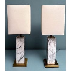 pair of marble lamps on brass bases with white linen shades