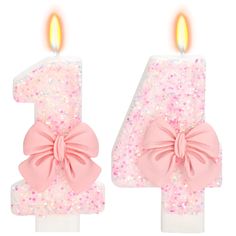 the number four candle is decorated with pink and white glitters, as well as a bow