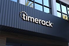 the time rack logo is displayed on the side of a building in front of palm trees