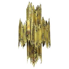 a large golden chandelier hanging from the ceiling in front of a white background