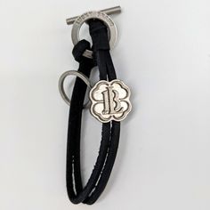 Lucky Brand Leather Bracelet Key Ring Clover Charm New In Sealed Box. Great For St. Patrick's Day! Black Leather Bracelet Suitable As A Gift, Metal Jewelry With Black Band For Gift, Classic Bracelets With Logo Charm As A Gift, Black Luxury Leather Bracelet For Everyday, Adjustable Silver Bracelet With Logo Charm, Adjustable Jewelry With Logo Charm As Gift, Elegant Everyday Engraved Leather Bracelet, Luxury Engraved Black Leather Bracelet, Luxury Black Engraved Leather Bracelet