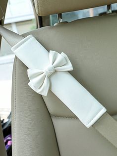 a white bow on the back seat of a car