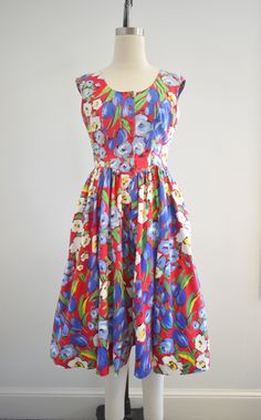 "Description: 1980s red floral cotton dress. Button front bodice and attached waist ties. It has a full, gathered skirt. Sleeveless. The skirt has hip pockets. Back elastic waist. Condition: In good condition. No holes or stains. It is overall a little dingy from age. Designer: Robbie Bee Stated size: 8 Measurements: Armpit to armpit: 18\" Bodice length: 15\" Overall length: 44\" Waist: 26-32\" Hips: free Armhole circumference: 15\" ---> If you need an order shipped by a particular date or sh Floral Cotton Dress, Gathered Skirt, Cotton Dress, Red Floral, Waist Tie, Cotton Dresses, Blue Floral, Red And Blue, Bodice