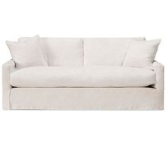 a white couch with two pillows on it