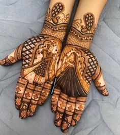 two hands with henna designs on them