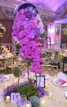 the table is set with flowers and candles