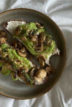 a plate with mushrooms and lettuce on it