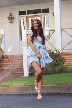 Blue mini dress with a white floral eyelet pattern, front bow tie, two tier ruffle, puff sleeves, and bubble hem details! Model is a 2/4 wearing a small! Denim Pants Romper, Athleisure Dress, Cocktail Dress Formal, Bubble Hem, Summer Bikinis, Blue Mini Dress, Boot Accessories, Romper Pants, Medium Blue