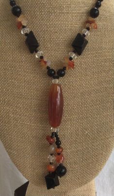 "Featuring this beautiful carnelian, black onyx and clear Quartz semi-precious beaded \"Y\" necklace. The necklace measures 16\" and is in excellent vintage condition. It has a silver tone lobster claw clasp." Vintage Black Gemstone Beads Necklace, Vintage Black Beaded Necklace With Gemstone Beads, Black Carnelian Jewelry With Natural Stones, Handmade Black Carnelian Necklace, Handmade Black Carnelian Jewelry, Healing Onyx Beaded Necklaces With Black Beads, Healing Onyx Beaded Necklace With Black Beads, Healing Onyx Beaded Necklace, Onyx Beaded Necklaces For Jewelry Making