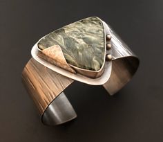 Handmade sterling silver cuff bracelet with a large septarian gemstone. Unique Hand Forged Cuff Bracelet For Formal Occasions, Unique Hand Forged Cuff Bracelet For Formal Events, Unique Sterling Silver Cuff Jewelry, Unique Polished Cuff Jewelry, Contemporary Silver Cuff Jewelry, Modern Gemstone Cuff Bracelet For Formal Occasions, Modernist Cuff Jewelry With Polished Finish, Modernist Polished Cuff Jewelry, Modernist Cuff Jewelry For Gift