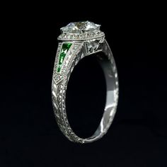 an engagement ring with a green and white diamond in the center on a black background