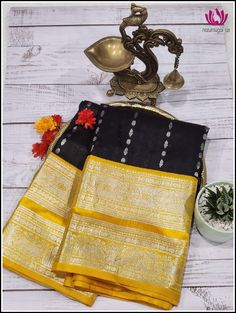 Venkatagiri silk/pattu Saree is woven in Venkatagiri of Nellor district in the Indian State of Andra Pradesh . It was registered as one of the geographical indications from Andhra Pradesh. Venkatagiri sarees are known for their fine weaving,fine quality and workmanship. This beautiful rich silk saree deep Black and buttas in silk zari all over the body. The contrast yellow pallu and border with silver zari compliments the saree. The yellow blouse piece matches the pallu with silver zari designs Black Art Silk Blouse Piece For Transitional Season, Transitional Black Art Silk Blouse Piece, Black Tussar Silk Blouse Piece With Pallu, Festive Black Tussar Silk Blouse Piece, Black Silk Traditional Wear For Diwali, Diwali Traditional Black Silk Wear, Black Katan Silk Blouse Piece With Traditional Drape, Black Chanderi Saree For Transitional Season, Black Raw Silk Saree For Wedding