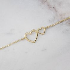 "\"Two hearts close together! What a wonderful feeling, warm and loving. Whether it is a gift or for you, the true meaning is always the same. Looking at the world through love makes everything more beautiful!\" --Fairy Goldcharm You may even combine it with our heart rings for a more loving look! https://www.etsy.com/listing/497167470/gold-heart-ring-gold-ring-rose-gold-14?ref=shop_home_active_46 https://www.etsy.com/listing/487581520/heart-ring-gold-heart-ring-yellow-gold?ref=shop_home_active_ Delicate Yellow Gold Heart Bracelet For Anniversary, Delicate Yellow Gold Heart Bracelet For Valentine's Day, Elegant Heart Shaped Bracelets For Anniversary, Yellow Gold Delicate Heart Bracelet For Valentine's Day, Delicate Gold Heart Bracelet For Anniversary, Dainty Yellow Gold Heart Bracelet For Mother's Day, Valentine's Day Double Heart Bracelets, Double Heart Yellow Gold Bracelet For Anniversary, Yellow Gold Heart Bracelet For Anniversary On Mother's Day