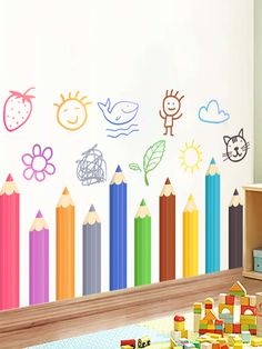 a child's room with colorful crayons and wall stickers on the walls