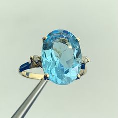 * Designer CID Blue Topaz Diamond Accents 14K Yellow Gold Statement Ring  * Ring size: 7 * Band width: 2mm * Weight: 3.7g  * Top of ring measures: 9/16" by 5/8" * Height: 5/16" * 1 blue topaz measures approximately: 14.5mm by 10mm * 2 diamonds measure approximately: 2mm round each * Marked: CID 14K * Ring can be resized for an additional fee. * Condition: as pictured. * G3860    Exported By ExportYourStore :) Gold Statement Ring, Ring Ring, Womens Jewelry Rings, Statement Ring, Blue Topaz, Favorite Jewelry, Statement Rings, Topaz, Jewelry Design