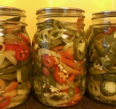 three jars filled with different types of vegetables