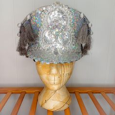 A stunning silver sequinned festival hat with delicate trims and embellisments which will really ensure you stand out from the crowd. The hat is a size large/60cm but can be made to fit smaller sizes by adding padding to the inside band. At the back, there is a band of elastic which secures the hat and makes it comfortable to wear.  This piece would be a fantastic addition to your festival wardrobe, party outfit, or fancy dress costume. If you are unsure of sizing or have any questions, please d Captain's Hat, Fancy Dress Costume, Festival Hat, Outfit Party, Dress Costume, Costume Hats, Fancy Dress Costumes, Festival Outfit, Colour Palette