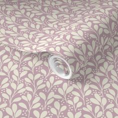 a pink and white floral wallpaper with leaves on the bottom, along with a roll of tape