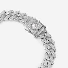 Elevate your style with the Golden Concept Cuban Link Bracelet, a masterpiece of luxury and craftsmanship. Crafted from premium sterling silver and adorned with natural Zircon gems, this bracelet radiates brilliance and sophistication. Weighing 42 grams and polished to perfection, it embodies elegance with a 12 mm thickness. Available in sizes S (17.5 cm), M (19 cm), and L (20.5 cm), it ensures a perfect fit, blending comfort with luxury. The meticulous attention to detail and flawless finishing White Jubilee Bracelet Jewelry With Cubic Zirconia, Luxury Diamond White Jewelry With Diamond Accents, White Jubilee Bracelet With Cubic Zirconia, White Cubic Zirconia Jubilee Bracelet, Vvs Clarity Diamond Bracelet, Elegant Cuban Link Chain Bracelet With Diamond Cut, Elegant Cuban Link Diamond Cut Bracelets, Elegant Sterling Silver Cuban Link Bracelet For Formal, Elegant Diamond Cut Cuban Link Chain Bracelet