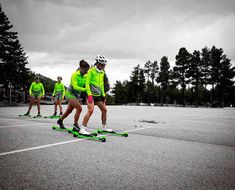 four people in neon green jackets are on skateboards