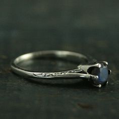 This fancy solitaire ring looks to come straight from the halls of Atlantis with it's elegant six prong setting and intricate etched details. Hand set in the crown like setting is a 5mm labradorite. This ring is masterfully oxidized to show off the exquisite detail. Your ring will be custom sized to fit and hand polished to a high shine. Deb is a professional jeweler that has dedicated over 15 years to her craft. Please don't hesitate to contact us with any questions or concerns. We are a small Classic Promise Ruby Solitaire Ring, Classic Solitaire Ruby Ring For Promise, Classic Solitaire Ruby Promise Ring, Silver Solitaire Moonstone Ring Round Cut, Wedding Solitaire Moonstone Ring In Sterling Silver, Sterling Silver Solitaire Moonstone Wedding Ring, Sterling Silver Solitaire Moonstone Ring For Wedding, Timeless Sterling Silver Moonstone Ring, Classic Solitaire Moonstone Ring Gift