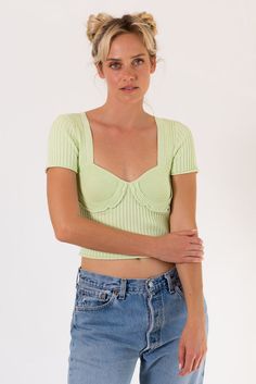 Stylist Pick! The Ripple Effect Top features a ribbed knit fabrication with corset style contrast ribbing at bust with ruffle detail. Short Sleeve and semi cropped hem. Color: Lime Merrow Detail At Bust With Ruffle Trim Ribbed Short Sleeve Semi Cropped Acrylic Model Wearing Size Small and is 5'7" Tall, 32A Bust, 26 In Bottoms Shimmer Blouse, Forever 21 Activewear, Ripple Effect, Lace Short Sleeve Top, Buy Sweaters, Sweater Crop, Square Neck Top, Kimchi Blue, Crop Top Sweater