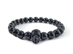 This bracelet is made with 8mm Black Tourmaline Beads and a 304 Stainless Steel Skull Spacer bead. The black stainless skull bead is 9.5mm wide, 16mm long and 13mm thick. 💎Black Tourmaline, "The Bodyguard Stone" helps to expel negative energy, both physical and emotional. It also helps to promote feelings of self-confidence, power, inner-strength, bravery, motivation and courage. This stone also helps to manifest desires, accumulate wealth, and increase money flow in your life. 💕Handmade in the USA: Each bracelet is hand-crafted in the USA from genuine, high-quality gemstones and accents, along with durable 1mm elastic string. We are a female-owned small business located in Portland, Oregon, promoting positivity and well-being for our customers. Made with healing gemstones, precious meta Increase Money, Money Flow, The Bodyguard, Healing Gemstones, Halloween Bracelet, Skull Bracelet, Tourmaline Beads, Beaded Skull, Halloween Jewelry