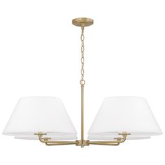 a brass chandelier with three white shades