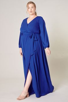 Warm and inviting, the Wholehearted Maxi Dress is a perfect combination of modest and sultry. Long balloon sleeves frame a surplice neckline separated by a tie at the waist, creating a forgiving faux wrap. The skirt maintains an airy and flowy shape that trails behind as you walk down the aisle. - Chiffon- Faux wrap- Keyhole- Elastic waist- Comes in 14 ColorsSize + Fit - Model is 5'9" and wearing size 2X- Measurements taken from size 2X - Chest: 36 1/2"- Length: 66" Fabric Self: 100% PolyesterLi Flowy Belted Wrap Dress With Surplice Neckline, Flowy Faux Wrap Maxi Dress, Flowy Faux Wrap Dress, Formal Flowy Wrap Dress With Surplice Neckline, Formal Flowy V-neck Wrap Dress, Flowy Faux Wrap Dress With Surplice Neckline, Flowy Faux Wrap V-neck Maxi Dress, Flowy Wrap Dress With Faux Wrap And Surplice Neckline, Flowy Wrap Dress For Date Night