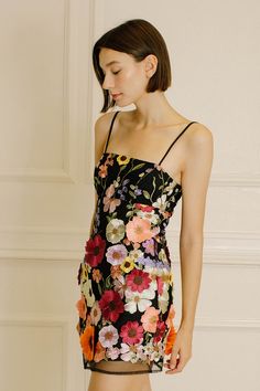 a woman in a short dress with flowers on it