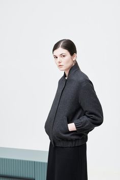 This heavy weight woolen jacket is our all-time best seller. Its polished but minimal design makes it an easy choice for cooler weather. An urban elegance staple, it features dropped shoulders and elasticated cuffs and hem. With two side pockets and an inside pocket, the DENITSA bomber jacket it’s a practical choice which can be combined with leisurewear or paired with a tailored look.Item: Handmade and made to orderMaterials: 100% Heavy weight wool Lining: 100%  viscoseStyle: Casual/StreetFit: Modern Winter Outerwear With Ribbed Cuffs, Oversized Varsity Jacket With Ribbed Cuffs For Fall, Varsity Jacket With Pockets For Workwear In Winter, Oversized Fall Varsity Jacket With Ribbed Cuffs, Fall Varsity Jacket With Ribbed Cuffs And Stand Collar, Modern Outerwear With Ribbed Cuffs For Work, Minimalist Long Sleeve Fall Outerwear, Street Fits, Statement Skirt