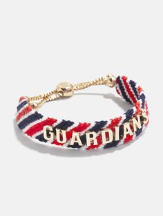 Proudly show off your team loyalty with the Cleveland Guardians MLB Woven Friendship bracelet. This bracelet is crafted with colorful woven thread, which creates a vibrant backdrop for your favorite game day rallying cheer. Secured with an easy pull-tie closure, this spirited and nostalgic accessory will be loved by fellow fans all season long. Please note: due to their handmade nature, each bracelet will be slightly unique. This is an officially licensed MLB product. Adjustable Team Spirit Friendship Bracelets For Game Day, Adjustable Multicolor Beaded Bracelets For Game Day, Adjustable Multicolor Sporty Bracelets, Multicolor Team Spirit Bracelets As Gift, Multicolor Team Spirit Bracelets For Gift, Adjustable White Friendship Bracelets For Game Day, Casual Multicolor Bracelets For Game Day, Casual Adjustable Wristband For Fan Merchandise, Adjustable Multicolor Beaded Bracelets For Team Spirit