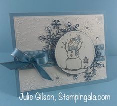 a card with a snowman on it and blue ribbon around the edge, that says julie gibson stampingala com