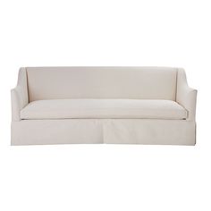 a white couch sitting on top of a white floor