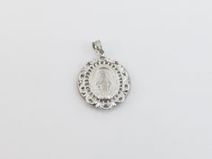 "fabulous 14k solid White Gold Virgin Mary Charm Pendant! * Material: 14k gold, Not plated or filled * Pendant Length: 1\" or 27 mm long not including the bail * Pendant Width: 7/8\" or 22 mm wide * Weight: 3.80 grams * Complementary Gift Box There is a prayer around Mary which says: O Mary conceived without sin pray for us who have recourse to thee. This Pendant is the same size as a quarter. Images may be enlarged to show detail and the item may look larger than it appears in person.In order t Elegant Commemoration Jewelry With Charms, Elegant Round Miraculous Medal Jewelry, Elegant Miraculous Medal Jewelry, White Gold Miraculous Medal Jewelry In Sterling Silver, White Gold Miraculous Medal Round Pendant, Elegant Miraculous Medal Round Pendant Jewelry, Silver Miraculous Medal For Wedding, Silver Miraculous Medal Jewelry For Wedding, Engraved White Gold Jewelry For Commemoration